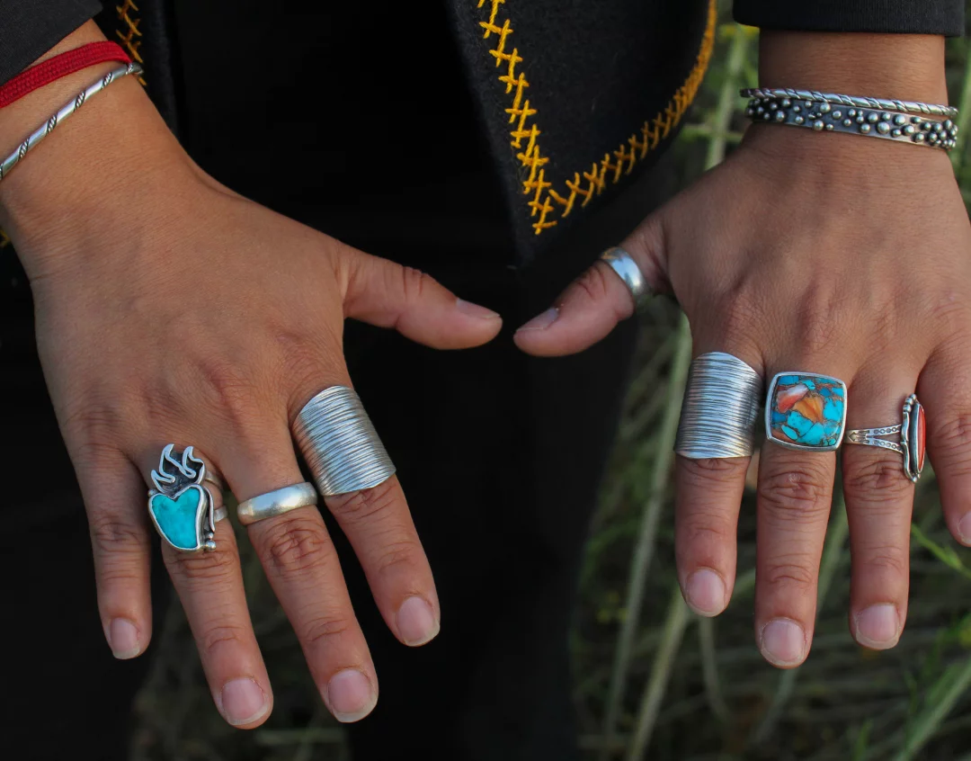 Hands of Native American person with turquoise rings.